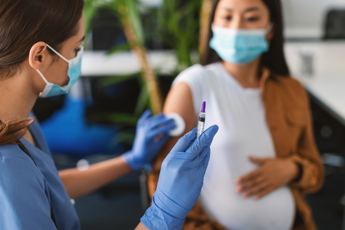 <p>Pregnant woman getting prepared to have the Covid-19 vaccination
